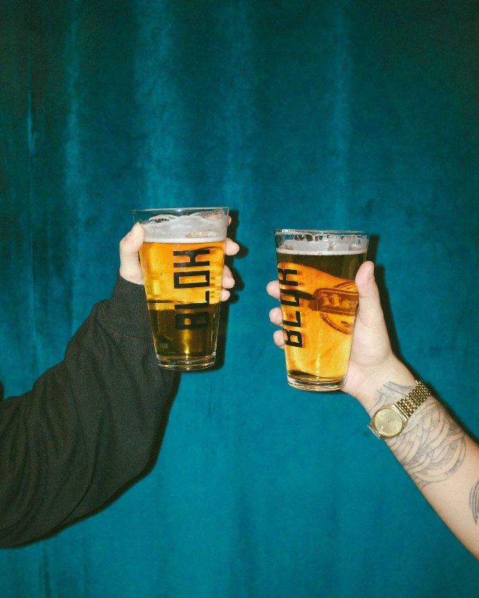 person holding clear drinking glass